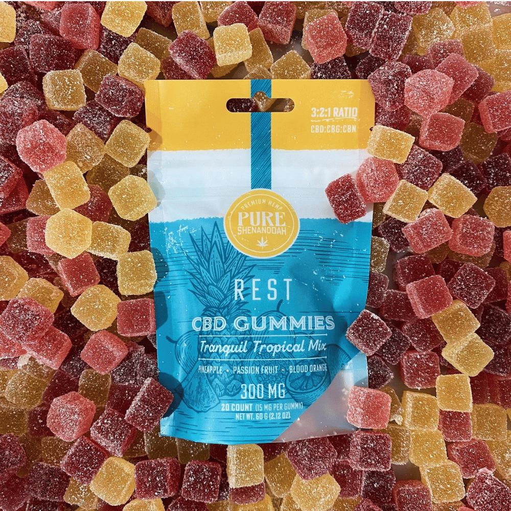 Rest CBD gummies package surrounded by colorful gummies