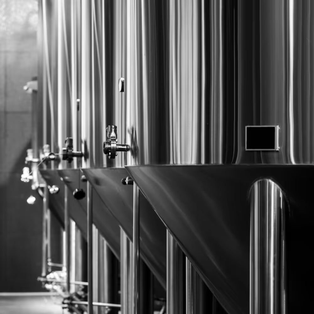 Stainless-steel fermentation tanks inside a beverage facility