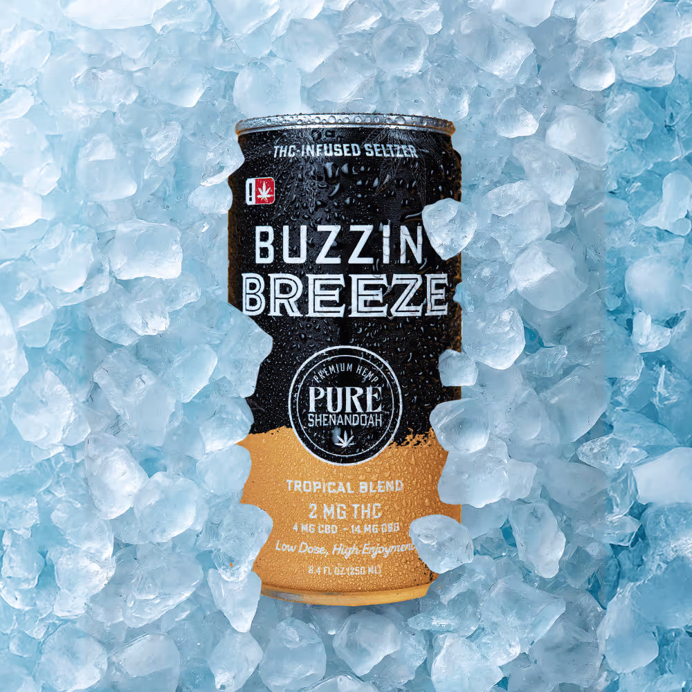 Buzzin Breeze tropical blend THC seltzer can surrounded by ice
