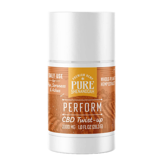Pure Shenandoah Perform CBD Twist-up in white container with orange wood-grain label, 2000 mg CBD, 1 oz (28.3 g) stick format.