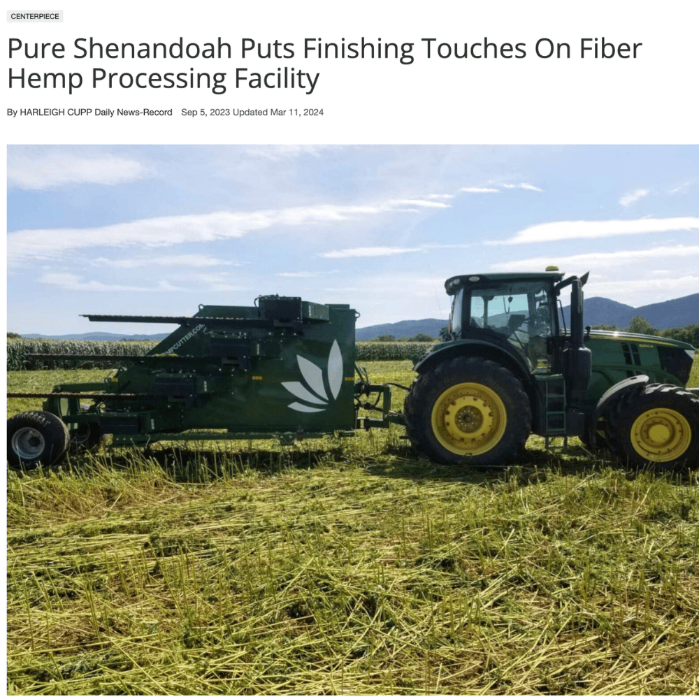 Tractor harvesting a hemp field beside the Pure Shenandoah processing facility