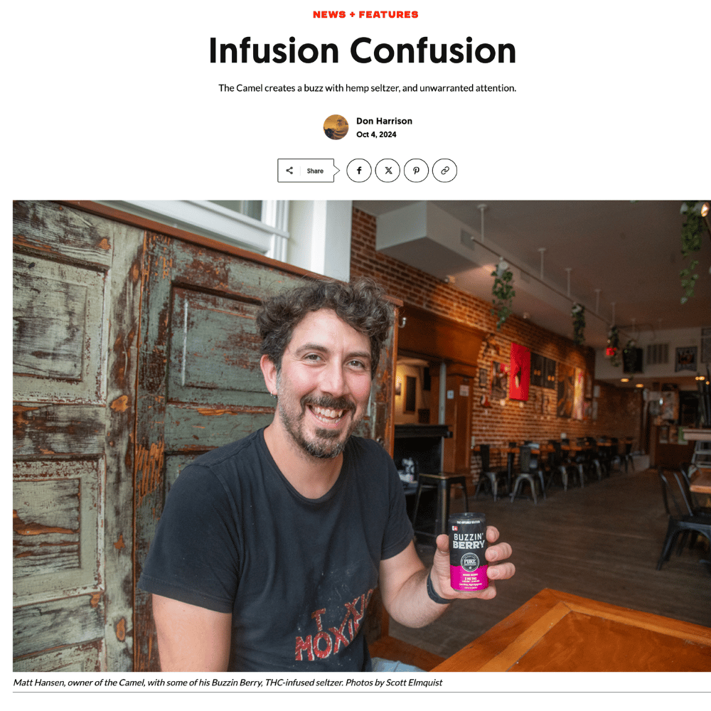 Richmond bartender holding a pink THC-infused drink inside a bar