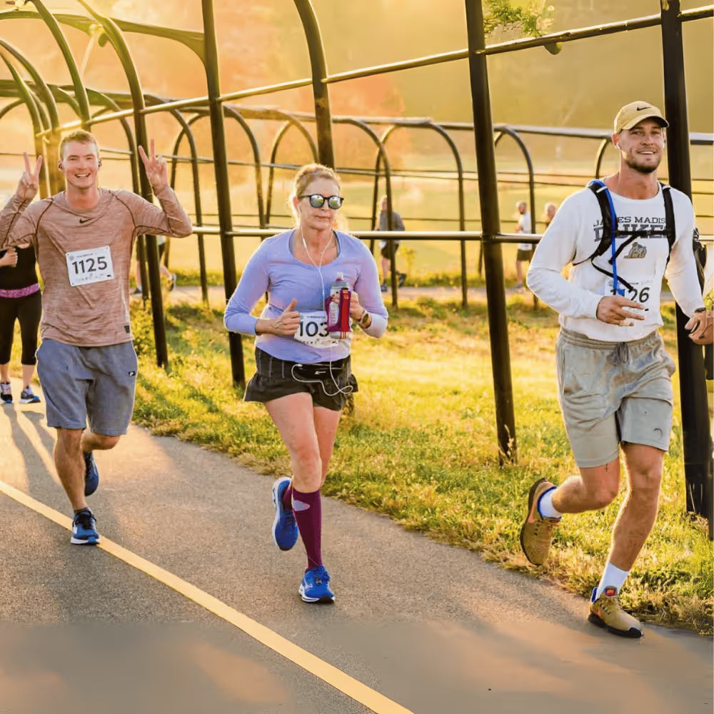 Runners passing a greenhouse during a Shenandoah Valley road race