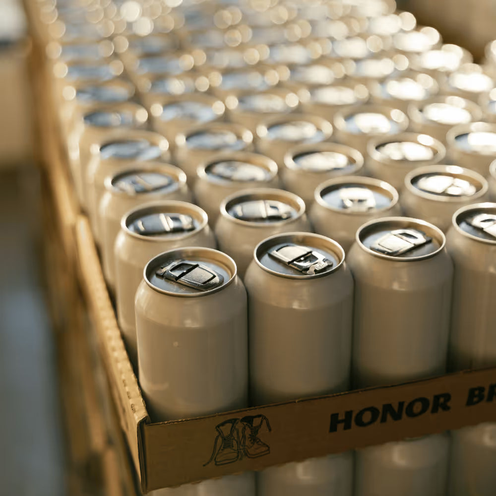 Rows of unlabelled beverage cans on a brewery production line