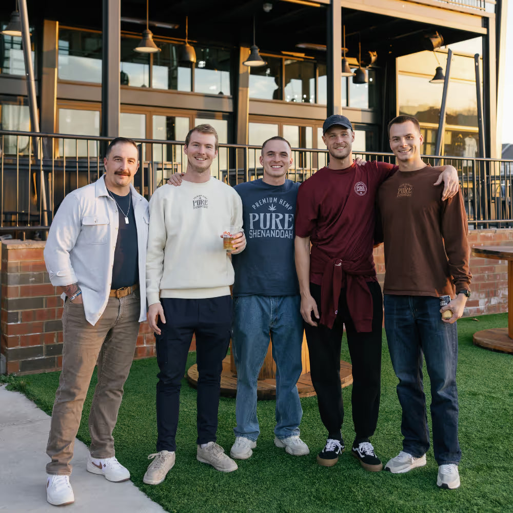 Five beverage-industry partners standing together outside a brewery