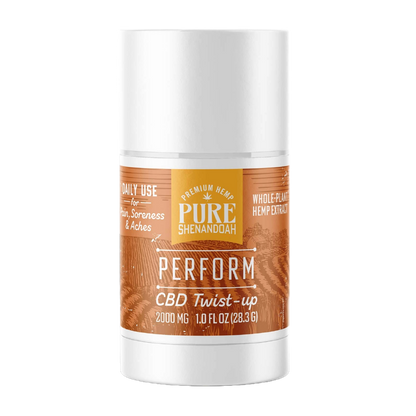 Pure Shenandoah Perform CBD Twist-up in white container with orange wood-grain label, 2000 mg CBD, 1 oz (28.3 g) stick format.